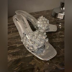 Silver clear lucite sandal are accented with round stones size 37